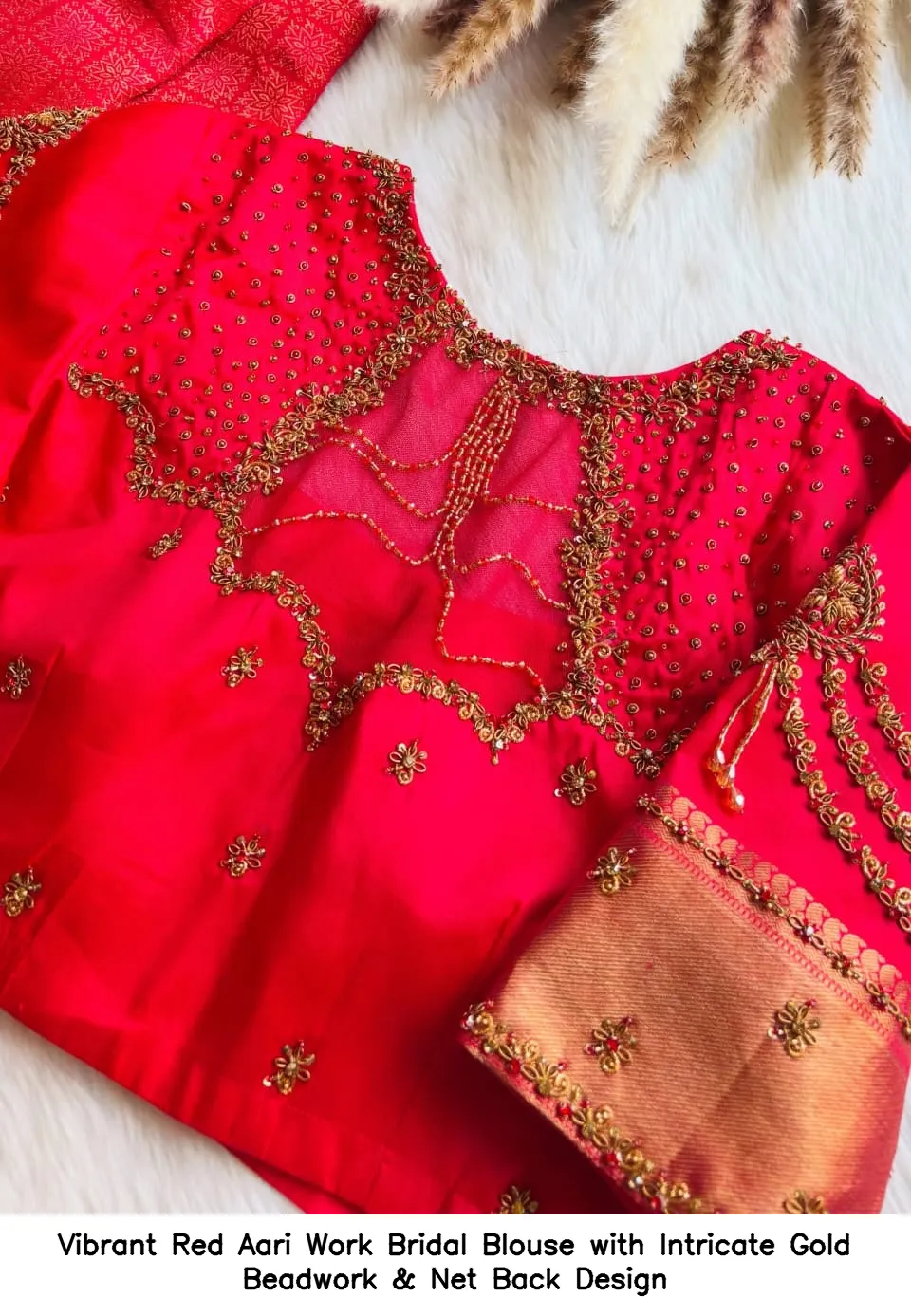 ​​Vibrant Red Aari Work Bridal Blouse with Intricate Gold Beadwork & Net Back Design