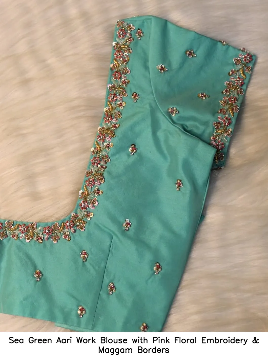 ​​​​​​​​Sea Green Aari Work Blouse with Pink Floral Embroidery & Maggam Borders